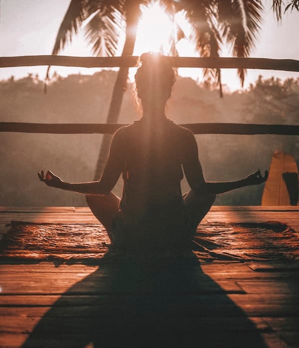 Woman sitting in a cross-legged meditation pose